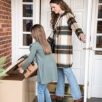 Woman and child retrieving package from LoxxBoxx Lifestyle